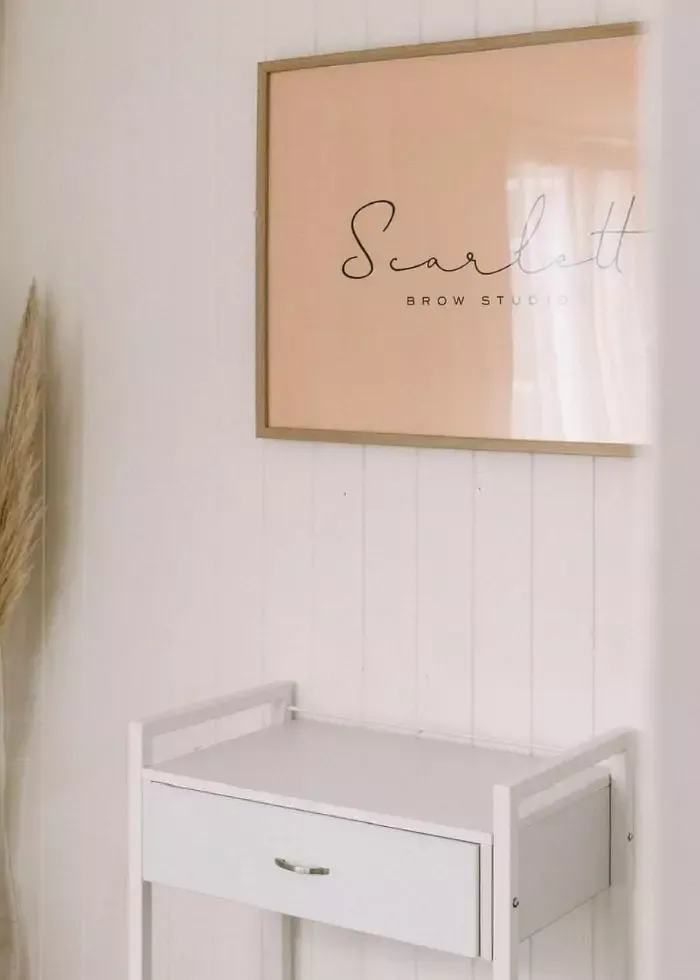 Minimalist salon interior with wall sign and trolley